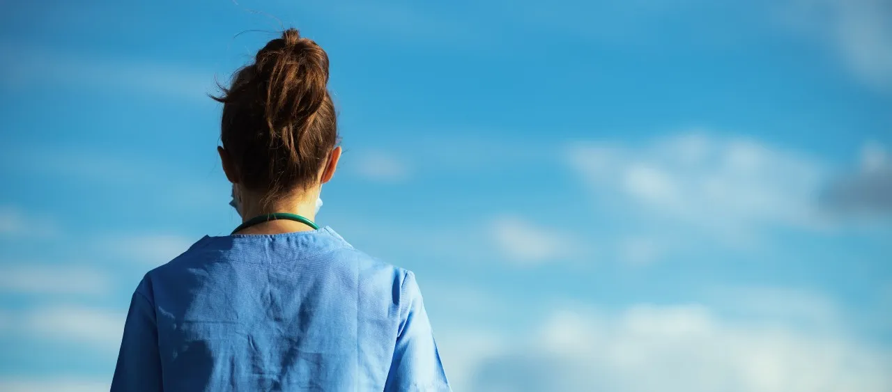 nurse standing in a blue sky background